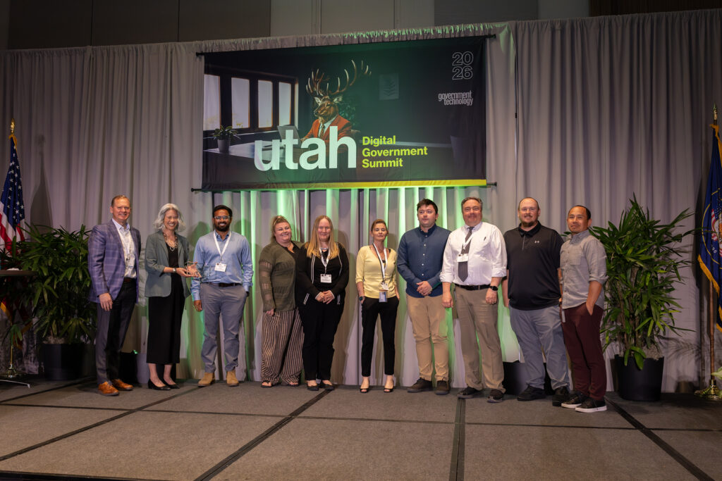 Courts and BOPP Connect team members on stage receiving award.