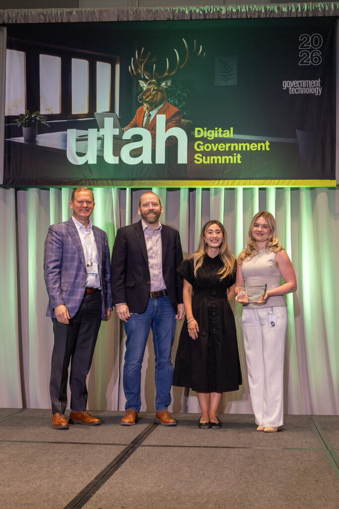 Digital Apostille Modernization team members on stage receiving award.
