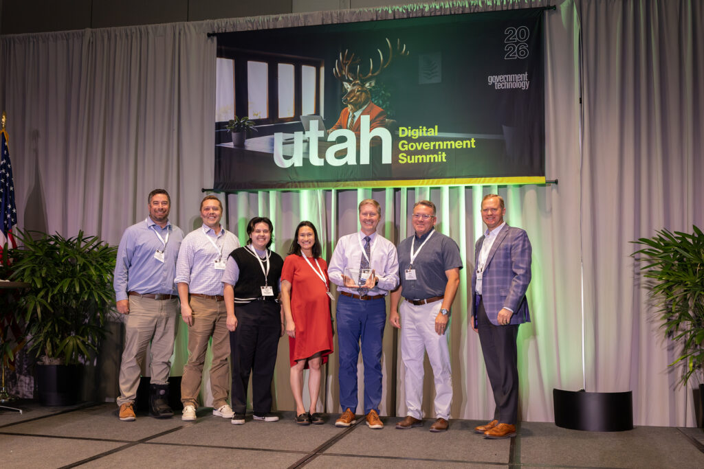 MyUtah team members on stage receiving award.